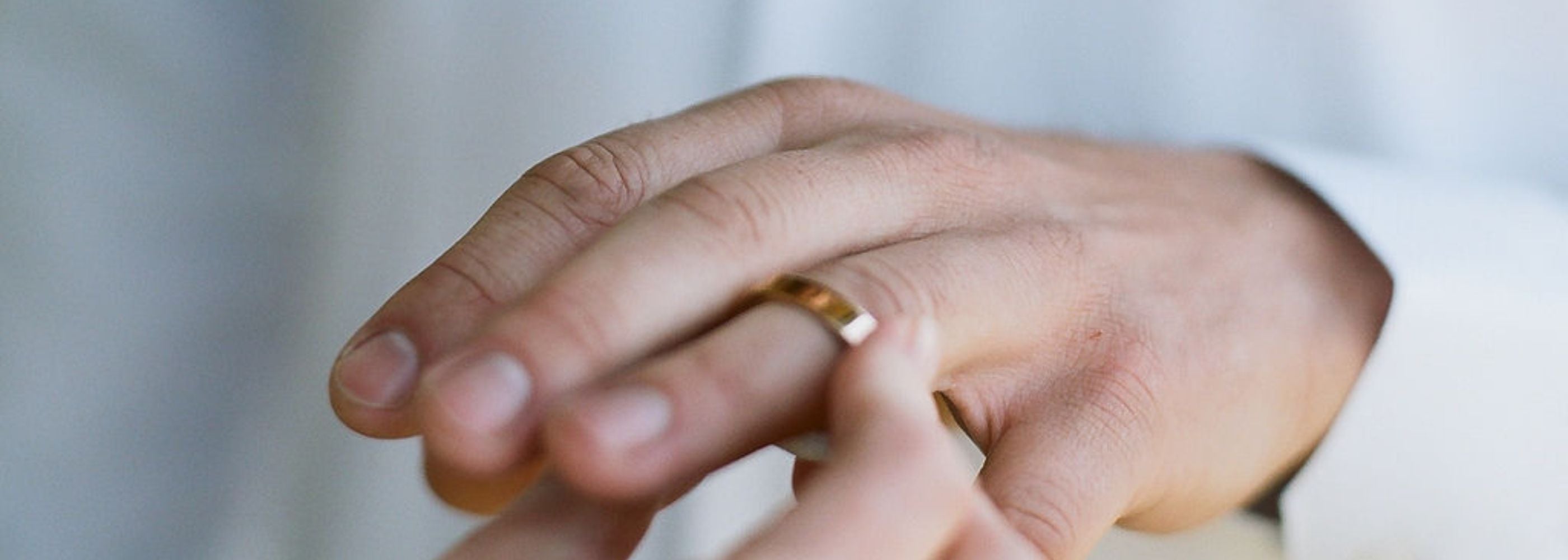 a man is proposed to and has a ring slipped onto his finger
