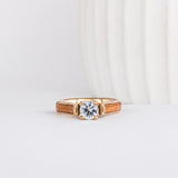 round cut lab grown diamond set beautifully in yellow gold and is shown with american elm wood inlays