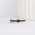a modern wooden wedding ring for men or women featuring white gold, a flat profile and a central inlay of dark black ebony wood