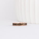 rose gold 4mm band with a straight edge profile with thin gold borders outlining a gray inlay of maple wood