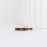rose gold 4mm band with a straight edge profile with thin gold borders outlining a gray inlay of maple wood