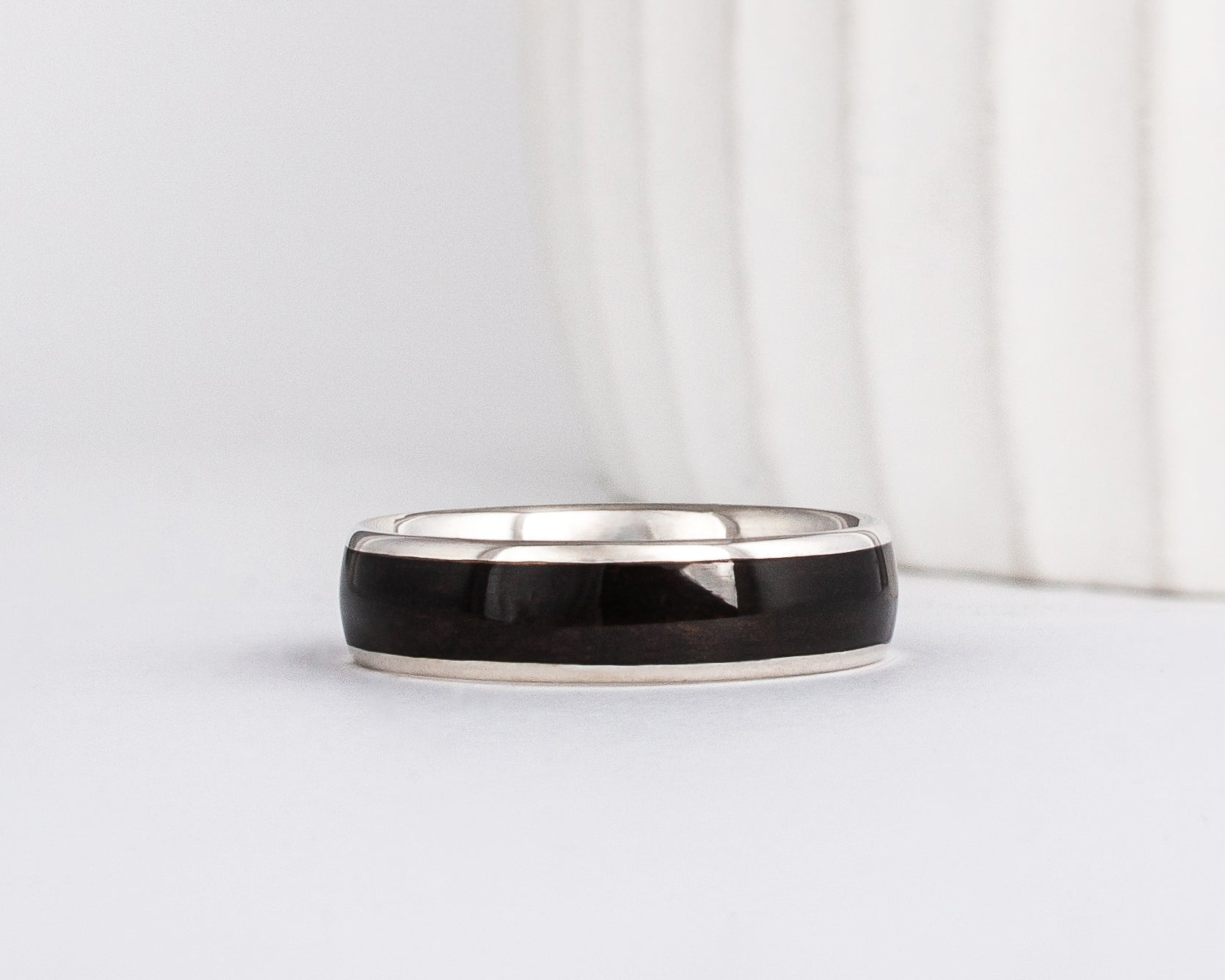 mens black wedding ring made from recycled white gold and ebony wood inlay