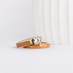 a wood wedding ring set made from yellow gold, american elm wood inlays, and a moissanite solitaire