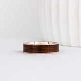a 6mm gold and wood ring made with rose gold and english oak wood inlay
