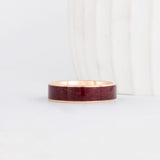 a yellow gold peyton style ring with rich purpleheart wood inlay