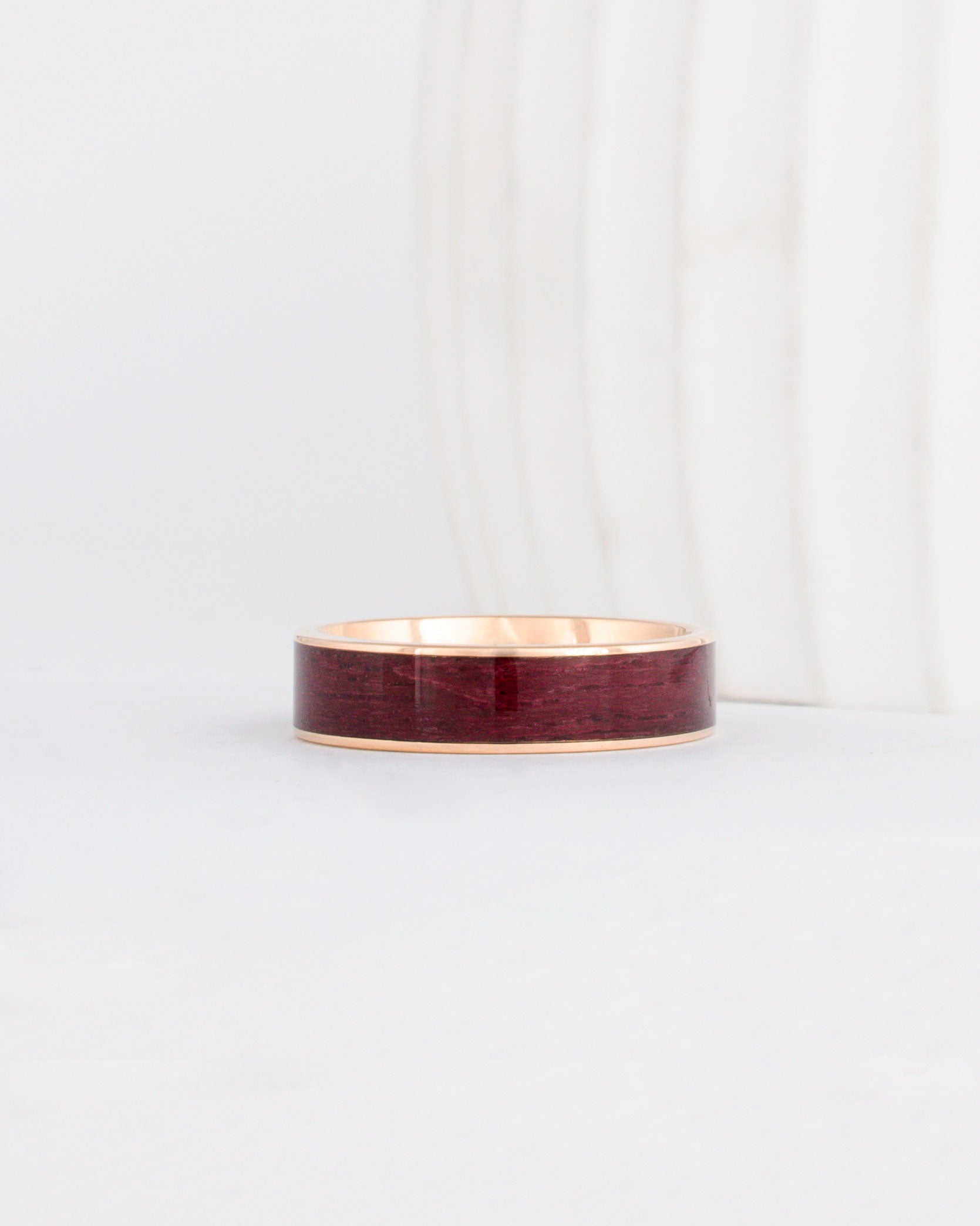 a yellow gold peyton style ring with rich purpleheart wood inlay